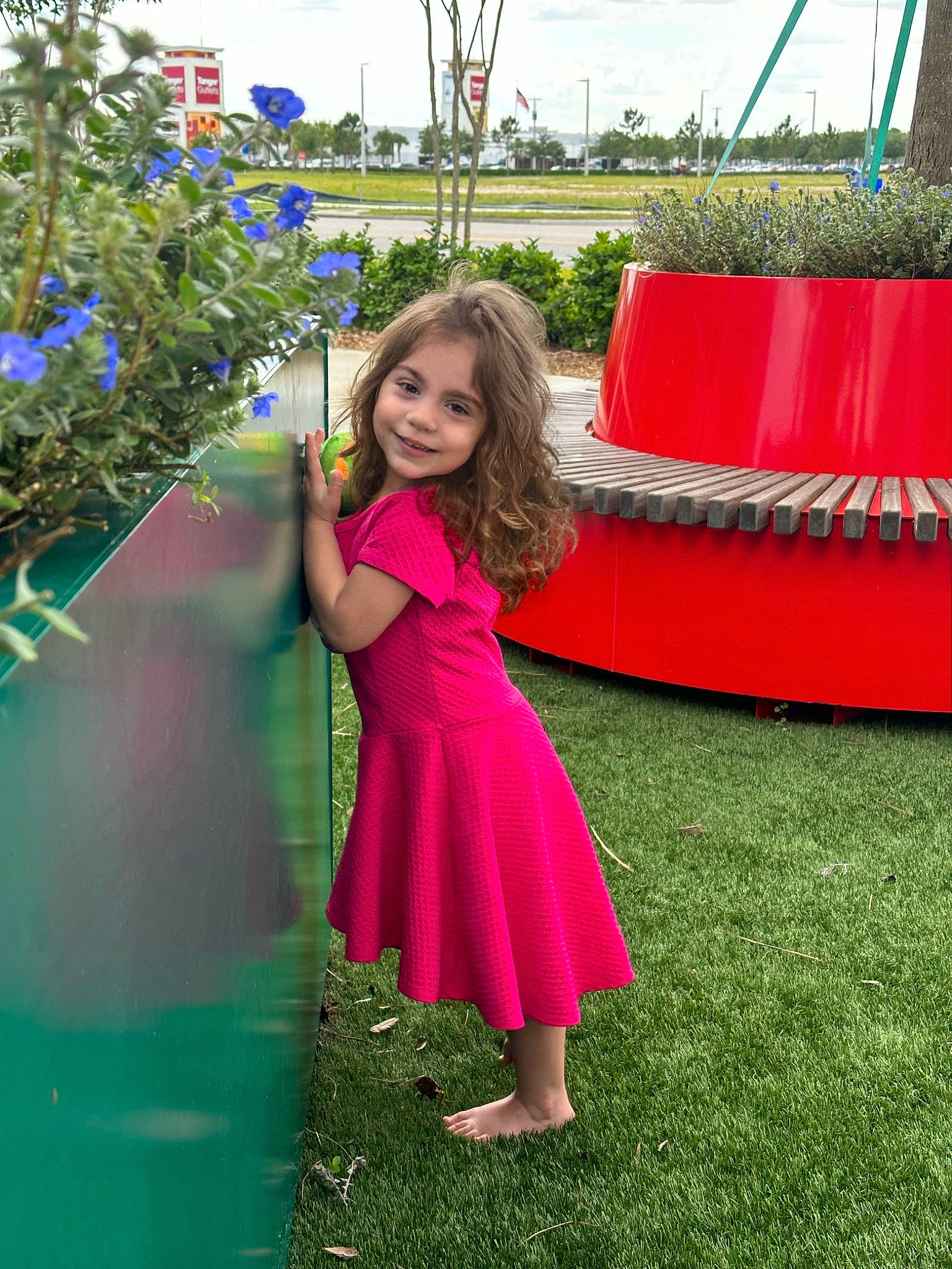 Lyla is registered to the contest to win money with this photo: day_dress, dress, electric_blue, event, formal_wear, fun, grass, happy, joy, leisure, magenta, one_piece_garment, pattern, people_in_nature, person, pink, plant, recreation, smile, toddler