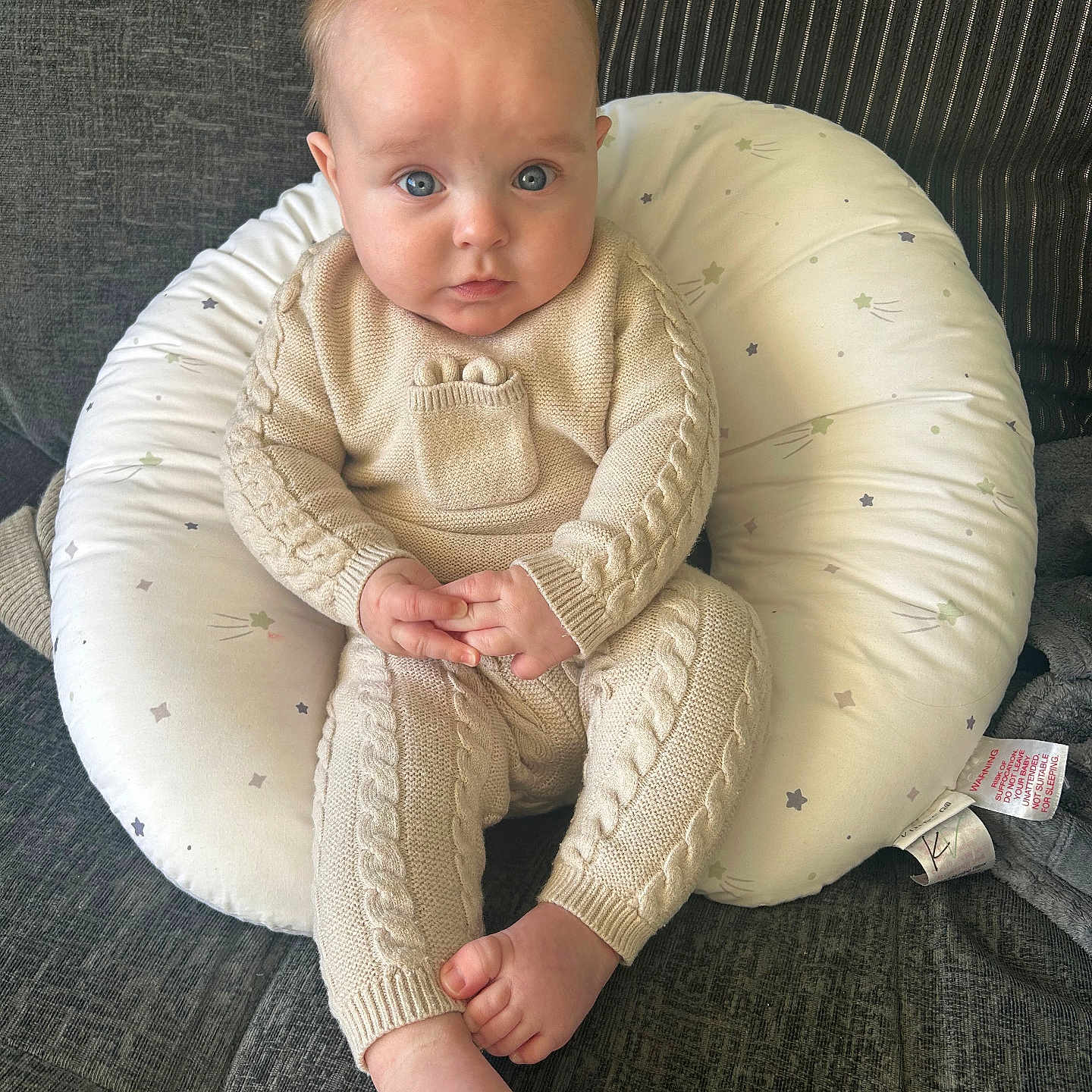 Liam is registered to the contest to win money with this photo: baby, bodypart, chair, clothing, couch, cushion, face, finger, furniture, hand, head, homedecor, knitwear, pants, person, photography, portrait, sitting, sleeve, sweater