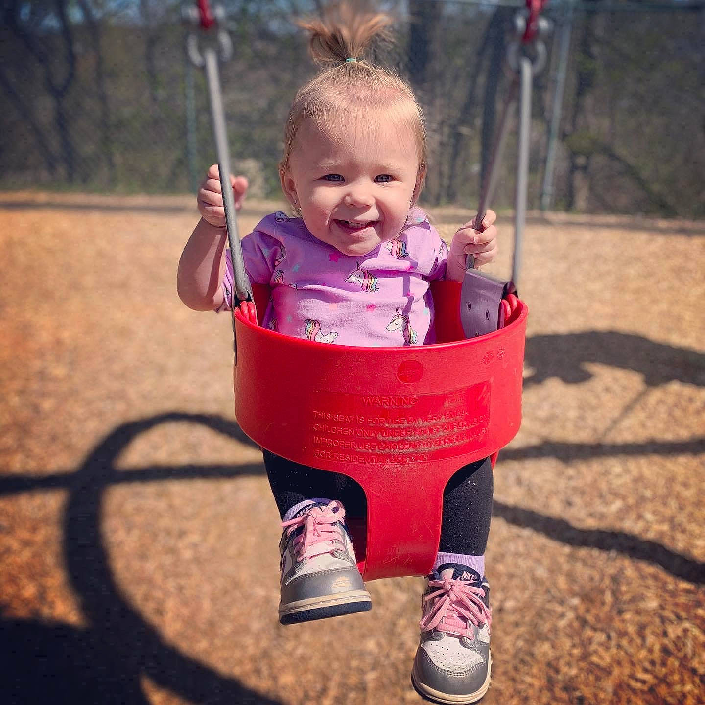 Adalina is registered to the contest to win money with this photo: child, fun, happy, joy, outdoor_play_equipment, person, pink, plant, play, playground, public_space, recreation, smile, summer, swing, toddler, tree, vacation