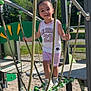 child, playground, rope_bridge, outdoor, smiling, daylight, sporty_clothing, air_jordan, shorts, sneakers, trees, mountains, rope, metal_bars, fence, gravel, bench, happy, person, summer