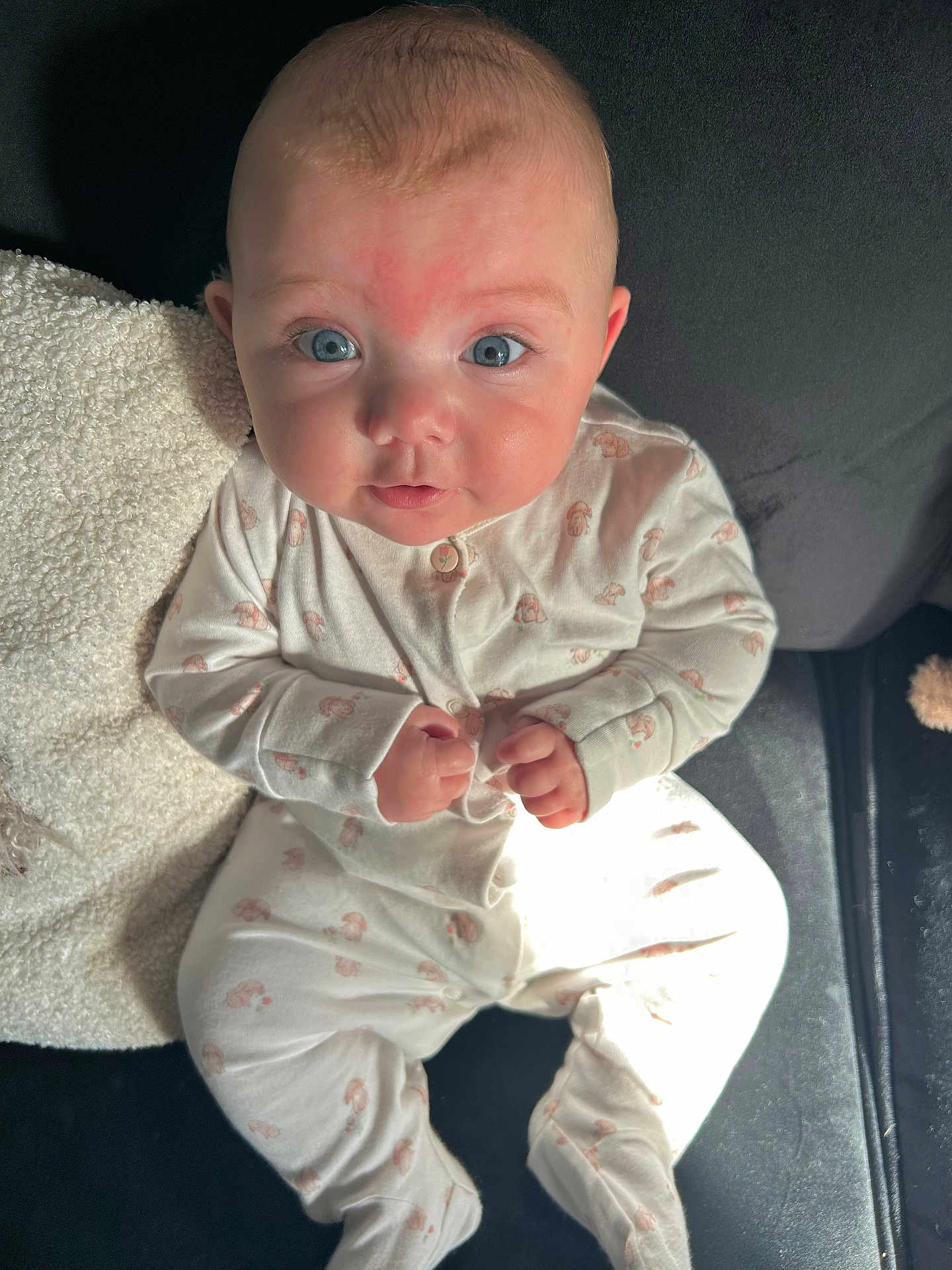 Hallie joined the competition — help win amazing prizes! baby, infant, blue_eyes, onesie, clothing, couch, blanket, indoor, child, person, cute, face, expression, sitting, hands, soft_lighting, texture, furniture, portrait, young
