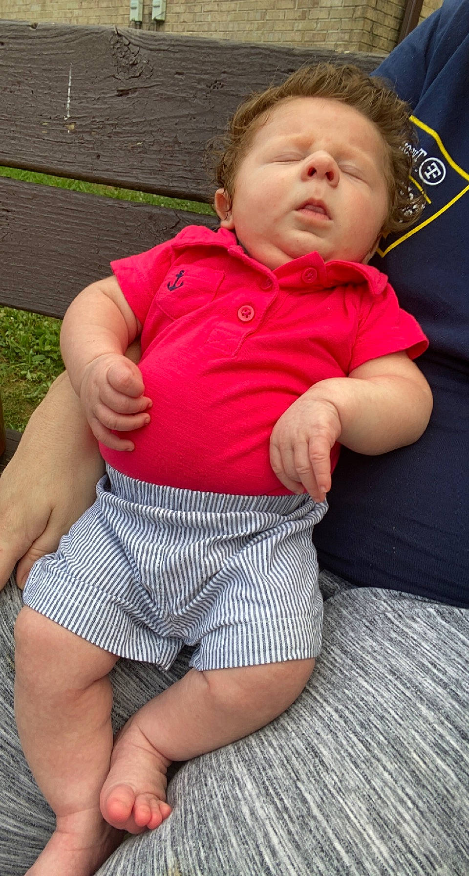 Benton is registered to the contest to win money with this photo: baby_toddler_clothing, chest, comfort, elbow, eye, face, grass, happy, head, human_body, human_leg, knee, person, plant, skin, sleeve, t_shirt, thigh, toddler, trunk