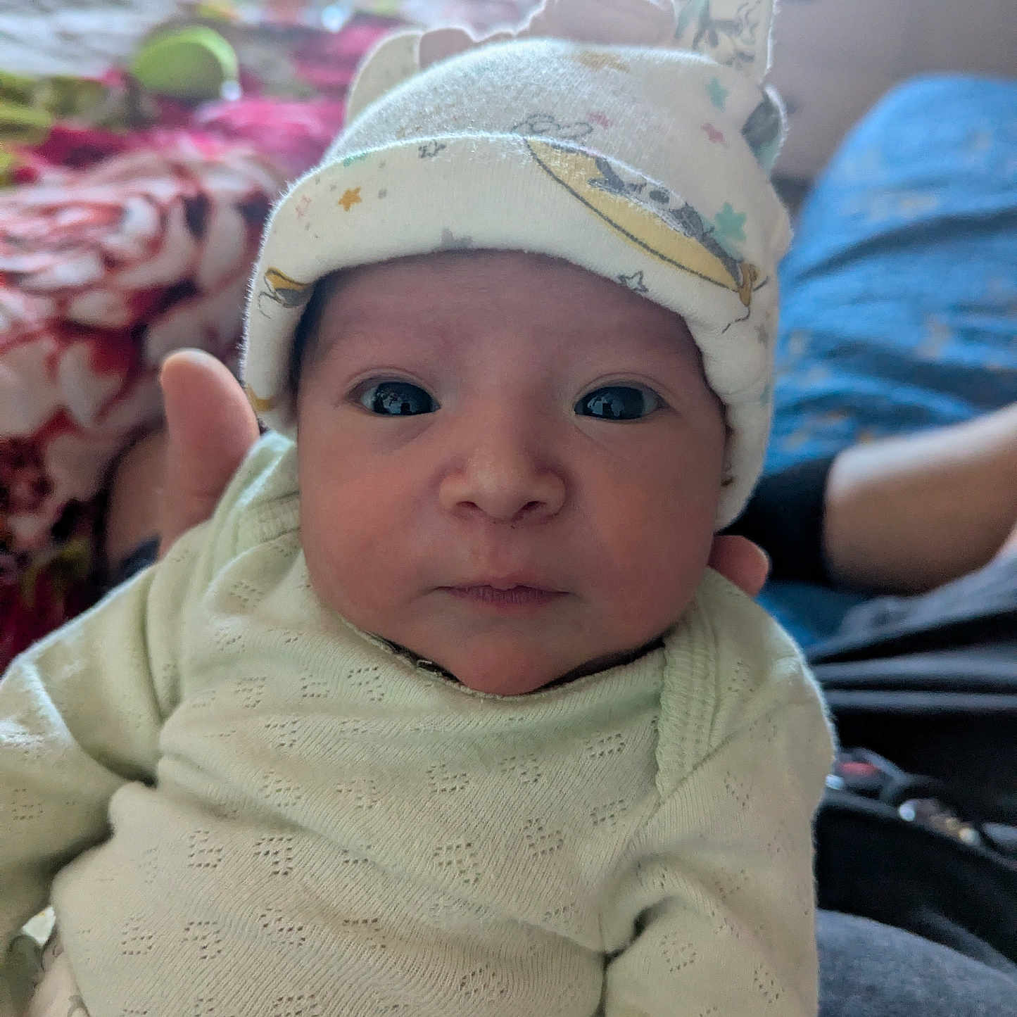 Azariyah is registered to the contest to win money with this photo: baby, bedspread, child, clothing, cute, face, hand, hat, home, indoors, infant, looking, newborn, person, portrait, seated, soft, sweater, warm, young