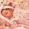 Valentina is registered to the contest to win money with this photo: baby, newborn, infant, child, portrait, lying_down, pink, blanket, headband, teddy_bear, flowers, roses, milestone_sign, one_month, sleepwear, indoors, cozy, face, looking_at_camera, photography