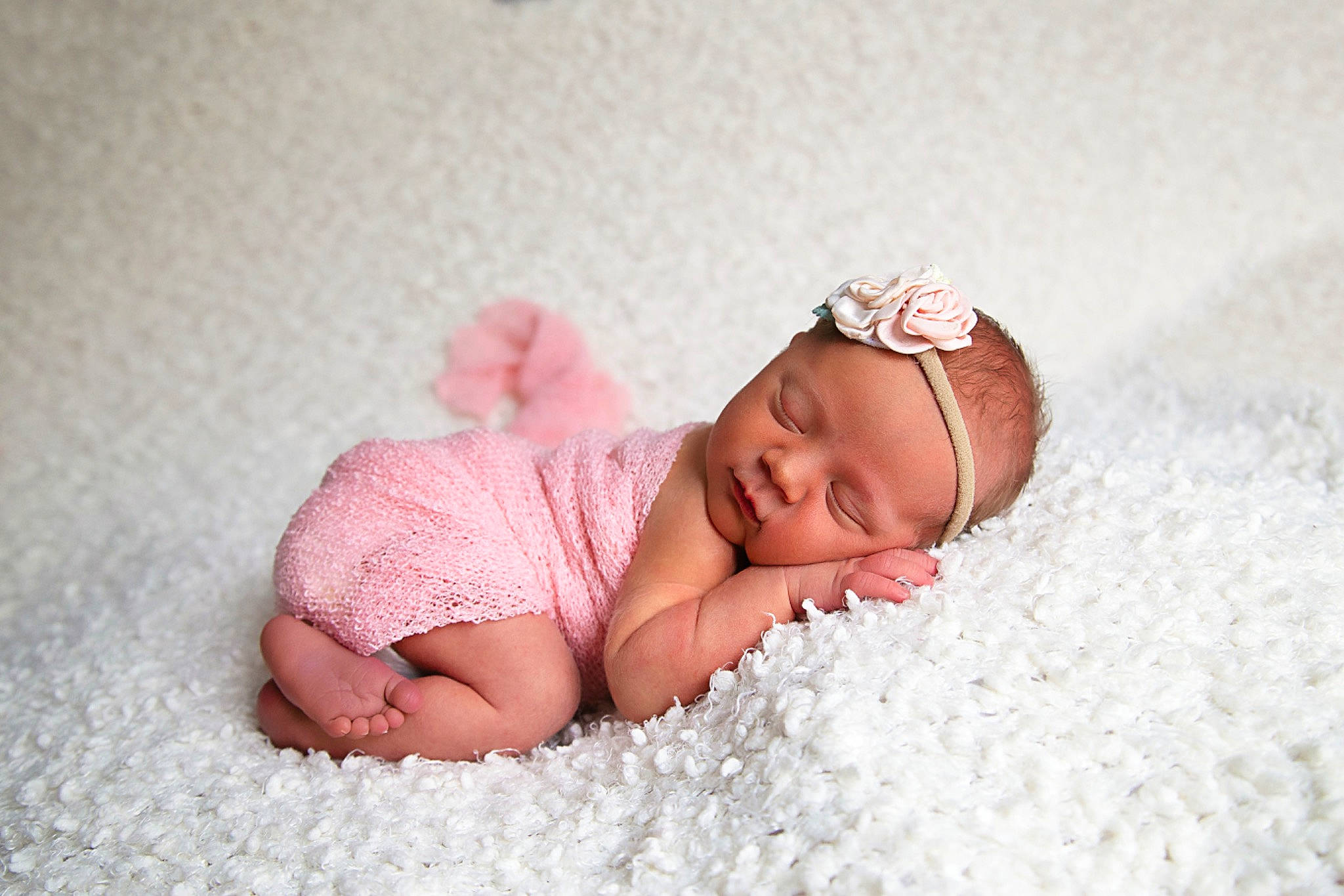 Georgia is registered to the contest to win money with this photo: arm, baby, baby_sleeping, baby_toddler_clothing, cap, comfort, eye, face, finger, flooring, grass, hand, head, headgear, headwear, knit_cap, leg, linens, lip, person