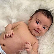 Zaden joined the competition — help win amazing prizes! baby, infant, newborn, portrait, smile, dark_eyes, bare_chest, navel, diaper, hand, soft_blanket, fur_blanket, cozy, closeup, head, hair, skin, lying_down, adorable, peaceful