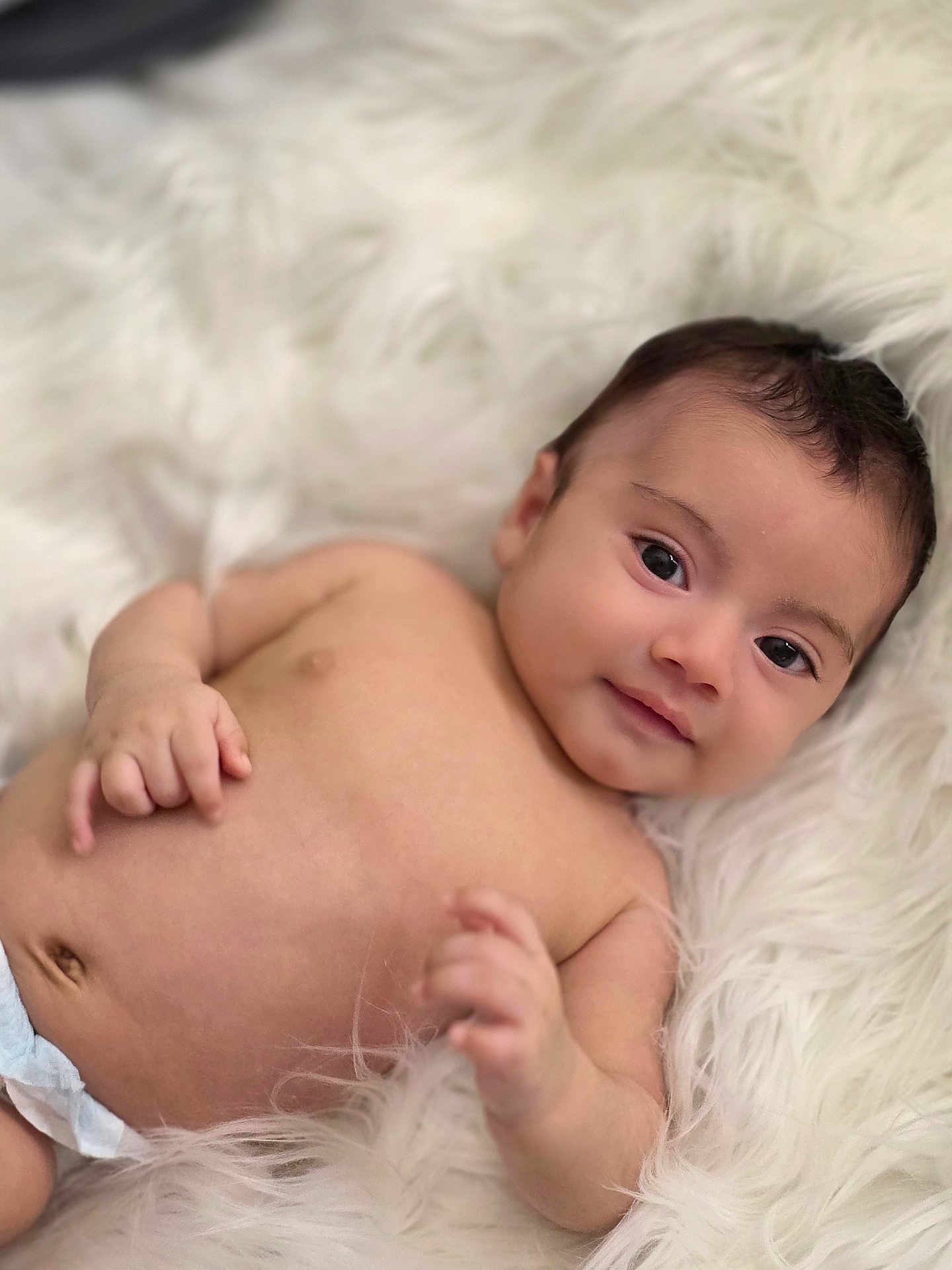 Zaden joined the competition — help win amazing prizes! baby, infant, newborn, portrait, smile, dark_eyes, bare_chest, navel, diaper, hand, soft_blanket, fur_blanket, cozy, closeup, head, hair, skin, lying_down, adorable, peaceful