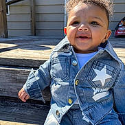 Legend Isaiah Powell is registered to the contest to win money with this photo: toddler, child, denim, jacket, pants, stars, smile, curly_hair, outdoor, wooden_steps, sunlight, happy, fashion, clothing, cute, baby, person, casual, daylight, portrait