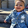 toddler, child, denim, jacket, pants, stars, smile, curly_hair, outdoor, wooden_steps, sunlight, happy, fashion, clothing, cute, baby, person, casual, daylight, portrait
