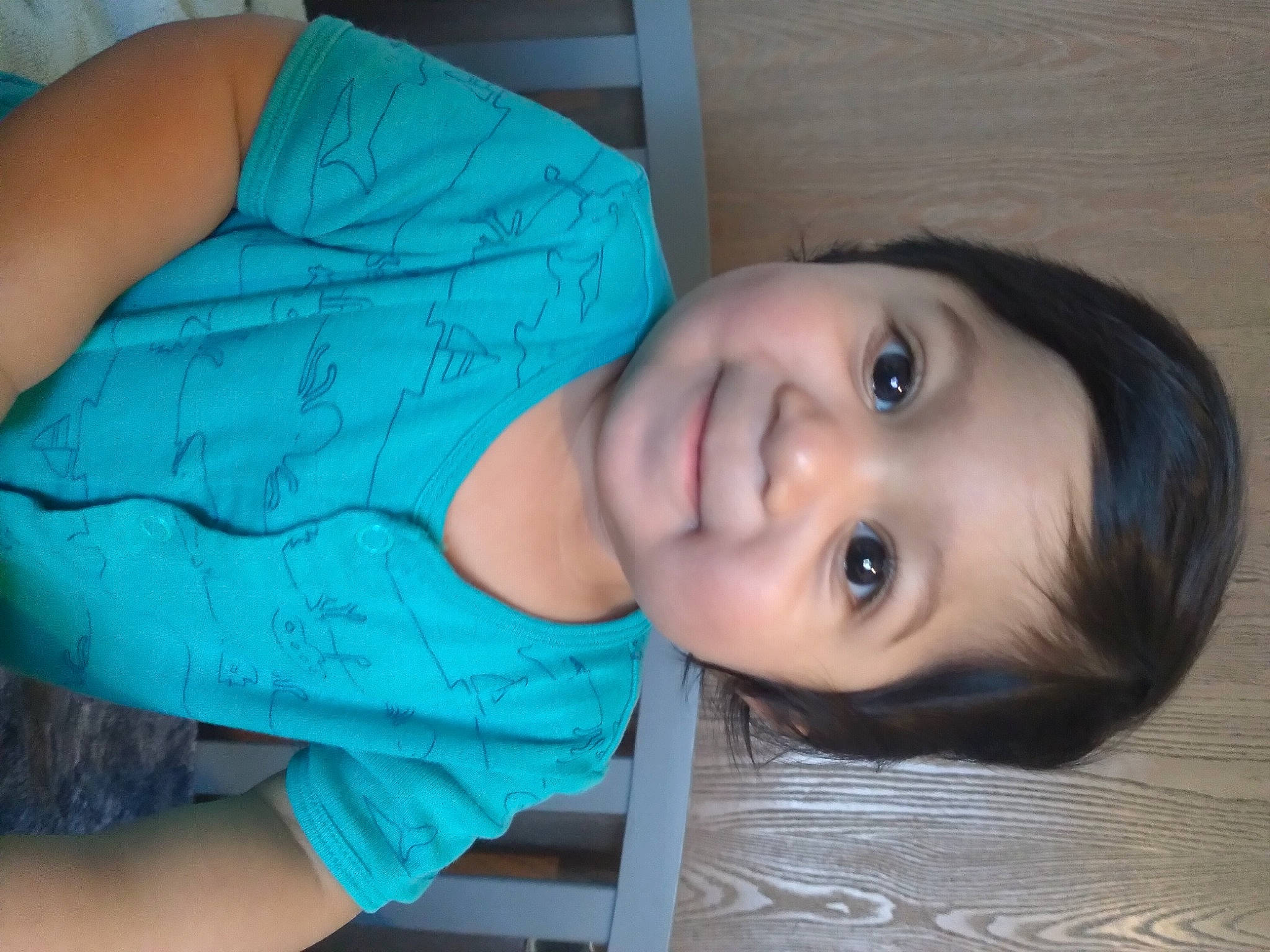 Mario is registered to the contest to win money with this photo: abdomen, blue, cheek, child, elbow, electric_blue, eye, eyelash, flash_photography, happy, joy, lip, mouth, nose, person, portrait_photography, sitting, skin, smile, toddler