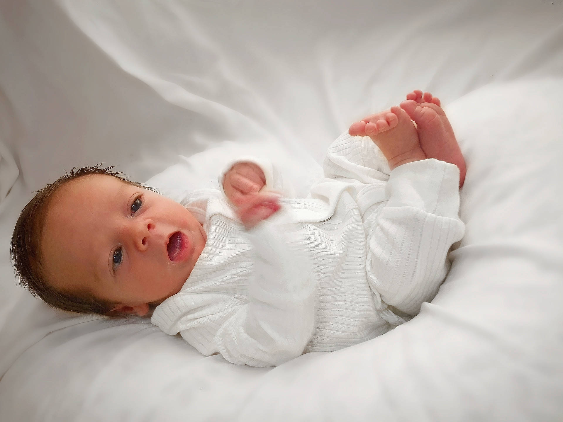 Halo is registered to the contest to win money with this photo: arm, baby, baby_toddler_clothing, child, comfort, dress, eye, flash_photography, foot, gesture, hair, hand, human_body, leg, linens, lip, person, skin, sleeve, textile