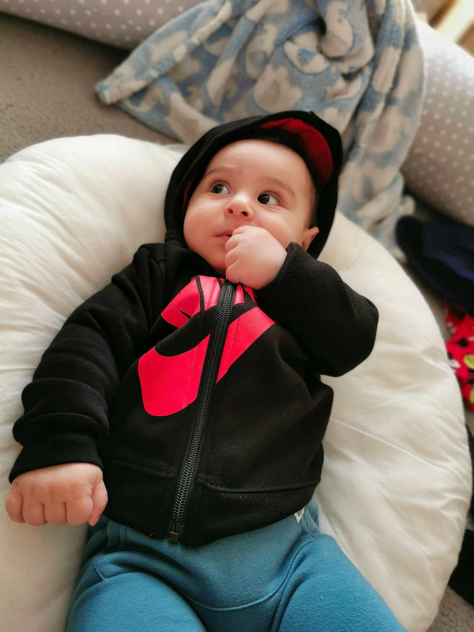 Ayan is registered to the contest to win money with this photo: baby, baby_toddler_clothing, cheek, child, comfort, eye, finger, fur, happy, hat, headwear, human_body, jacket, lip, nose, person, sitting, skin, sleeve, thigh