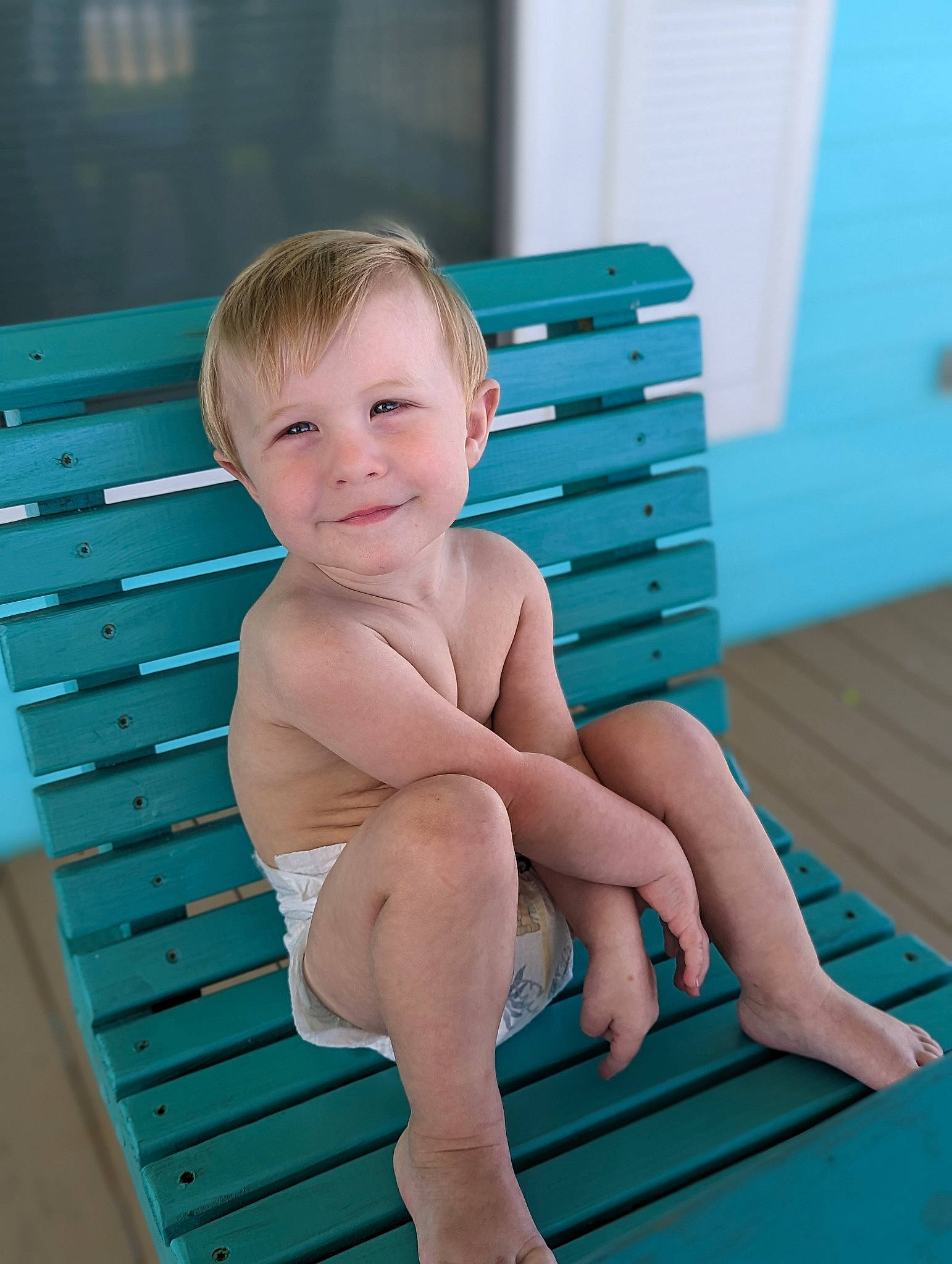 Ollie is registered to the contest to win money with this photo: aqua, baby_toddler_clothing, barefoot, blue, child, comfort, electric_blue, finger, foot, hairstyle, happy, human_leg, joint, joy, knee, leg, leisure, person, shorts, smile