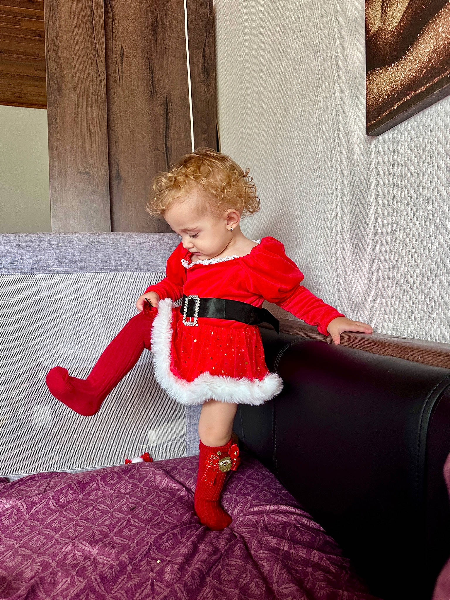 Briana Sophia Maria participe au concours pour gagner de l'argent avec cette photo : baby_toddler_clothing, blond, child, comfort, couch, day_dress, dress, embellishment, fashion_design, floor, flooring, human_leg, magenta, pattern, person, room, sitting, sleeve, sock, toddler