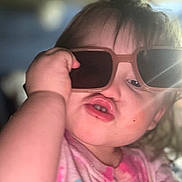 Elaina joined the competition — help win amazing prizes! toddler, child, sunglasses, pout, face, hand, pink_shirt, cartoon_print, indoor, portrait, cute, funny_face, baby, person, young_child, expression, casual_clothing, closeup, skin, hair