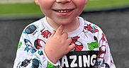 Jaxson is registered to the contest to win money with this photo: child, boy, smiling, portrait, outdoor, suburban, street, face, freckles, short_hair, blond_hair, sweatshirt, superhero, spiderman, hulk, marvel, standing, hand_gesture, daylight, vehicles