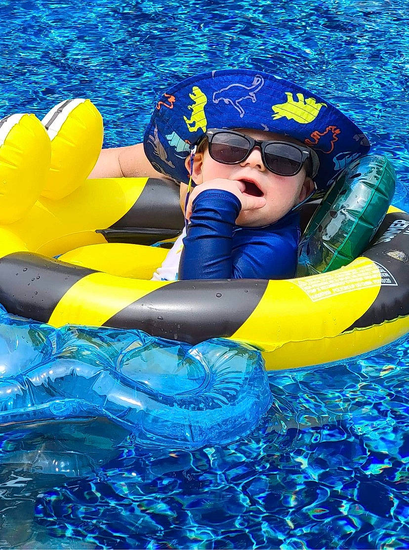 Camden is registered to the contest to win money with this photo: aqua, azure, blue, boats_and_boating_equipment_and_supplies, cap, electric_blue, eyewear, fun, games, goggles, happy, headgear, headwear, inflatable, leisure, lifejacket, person, personal_protective_equipment, recreation, sports