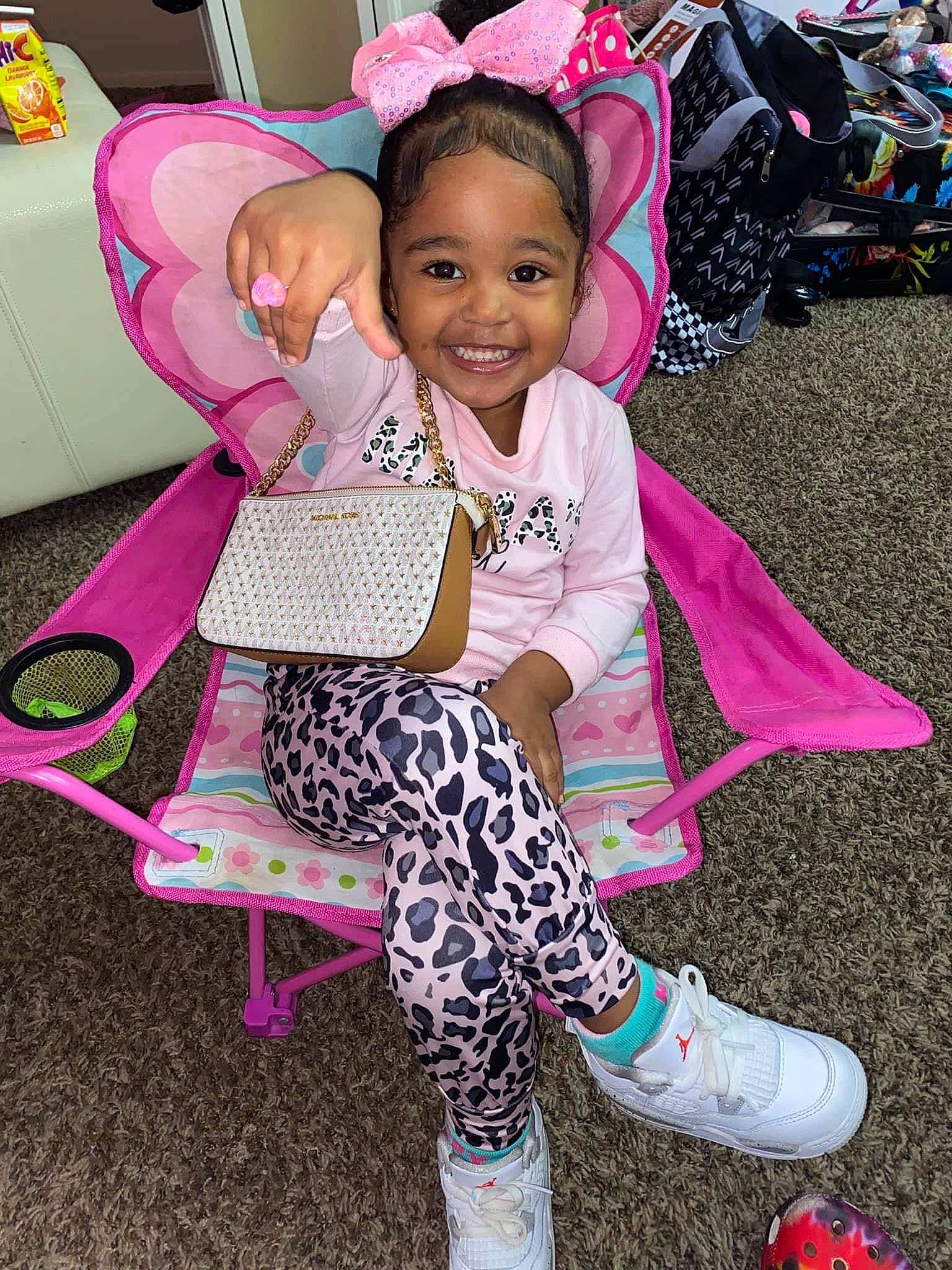 Reigna is registered to the contest to win money with this photo: baby_toddler_clothing, child, cool, event, fun, hairstyle, happy, joy, leisure, magenta, person, pink, purple, shoe, smile, snapshot, sneakers, sock, thigh, toddler