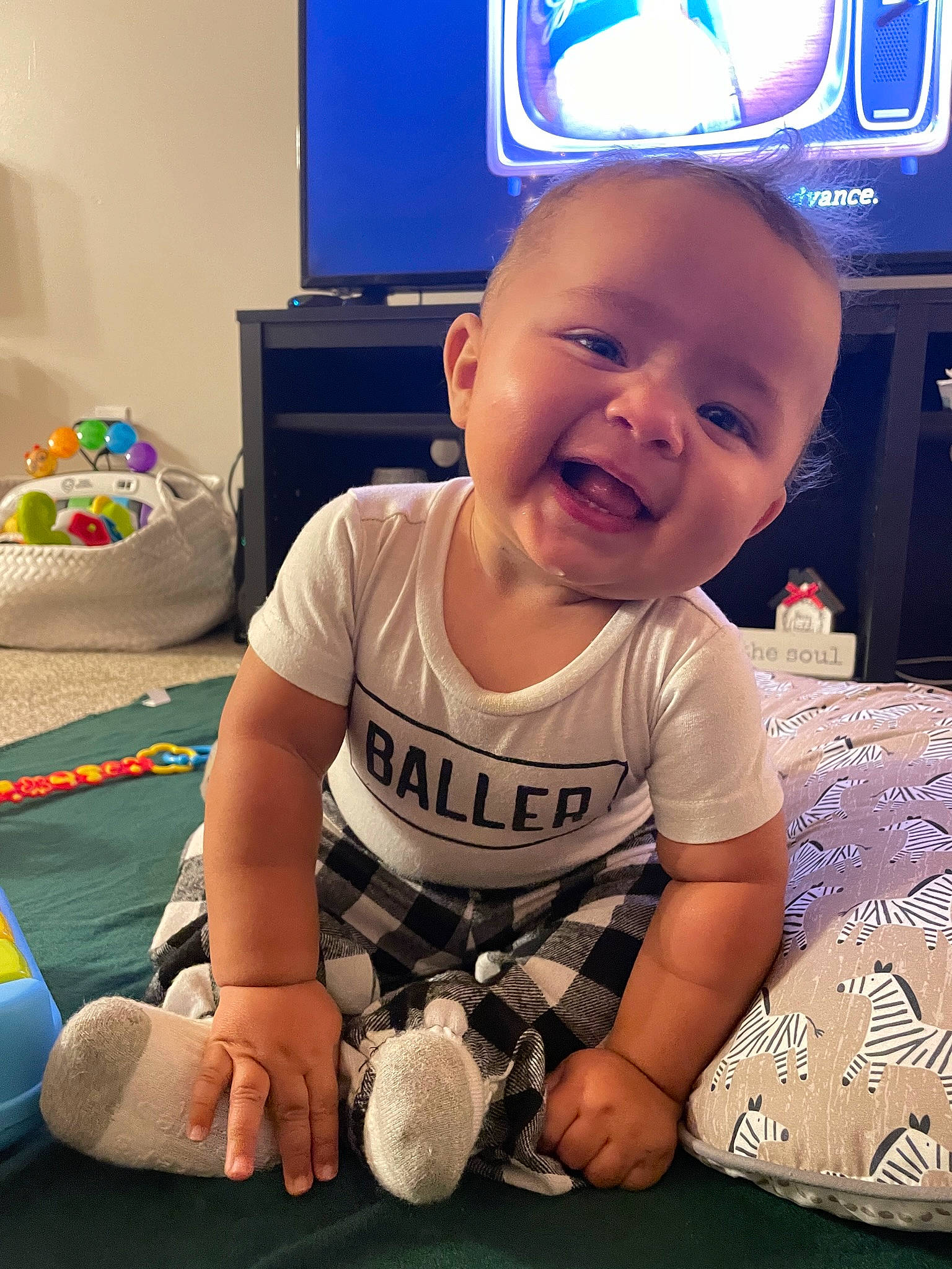 Keenan is registered to the contest to win money with this photo: baby, baby_toddler_clothing, child, cool, facial_expression, finger, flooring, fun, happy, head, mammal, mouth, organ, person, shorts, sleeve, smile, standing, t_shirt, television