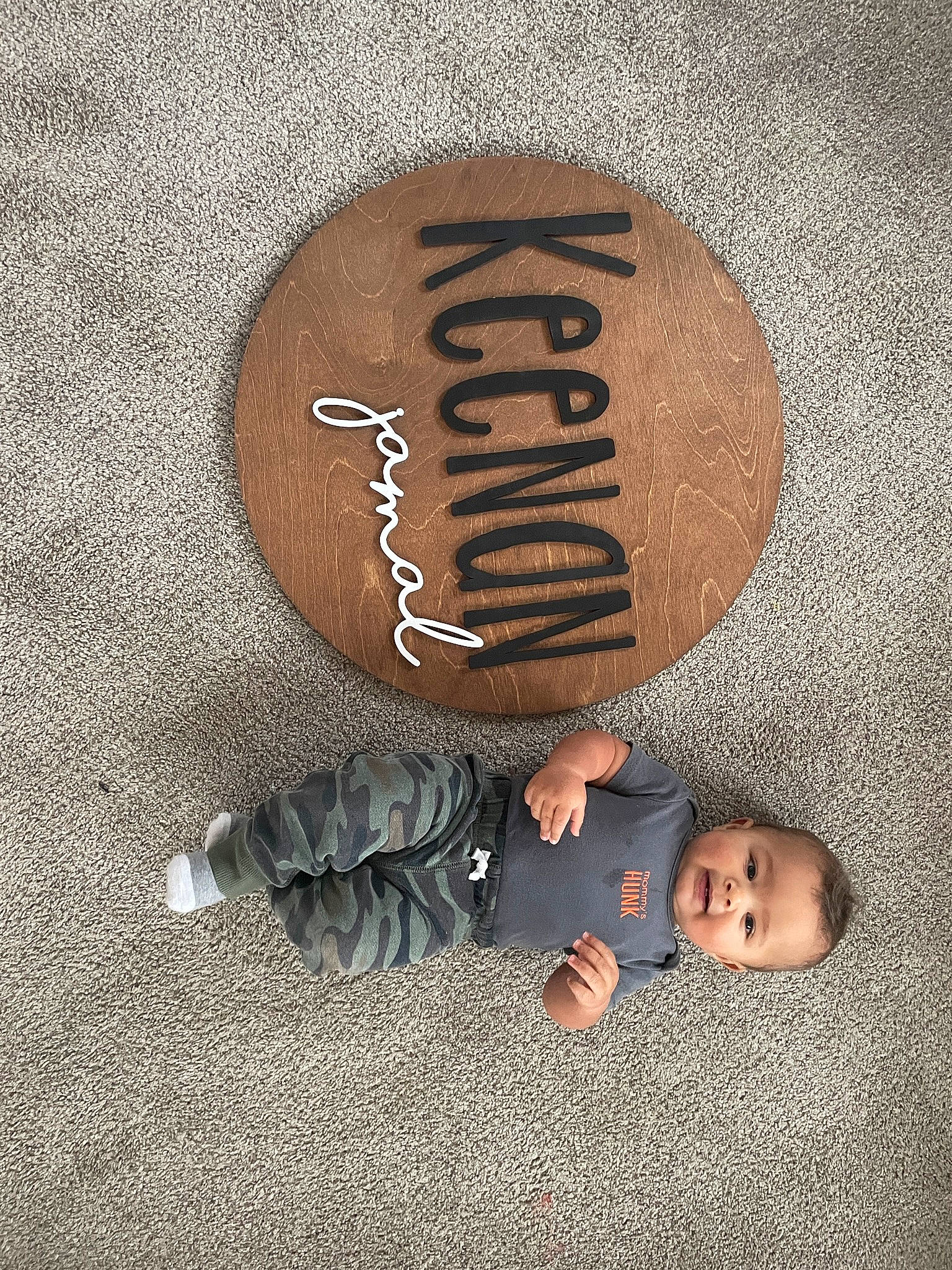 Keenan is registered to the contest to win money with this photo: baby, child, circle, flash_photography, flooring, font, foot, gesture, handwriting, happy, head, logo, metal, person, rock, shadow, sitting, still_life_photography, tints_and_shades, toddler