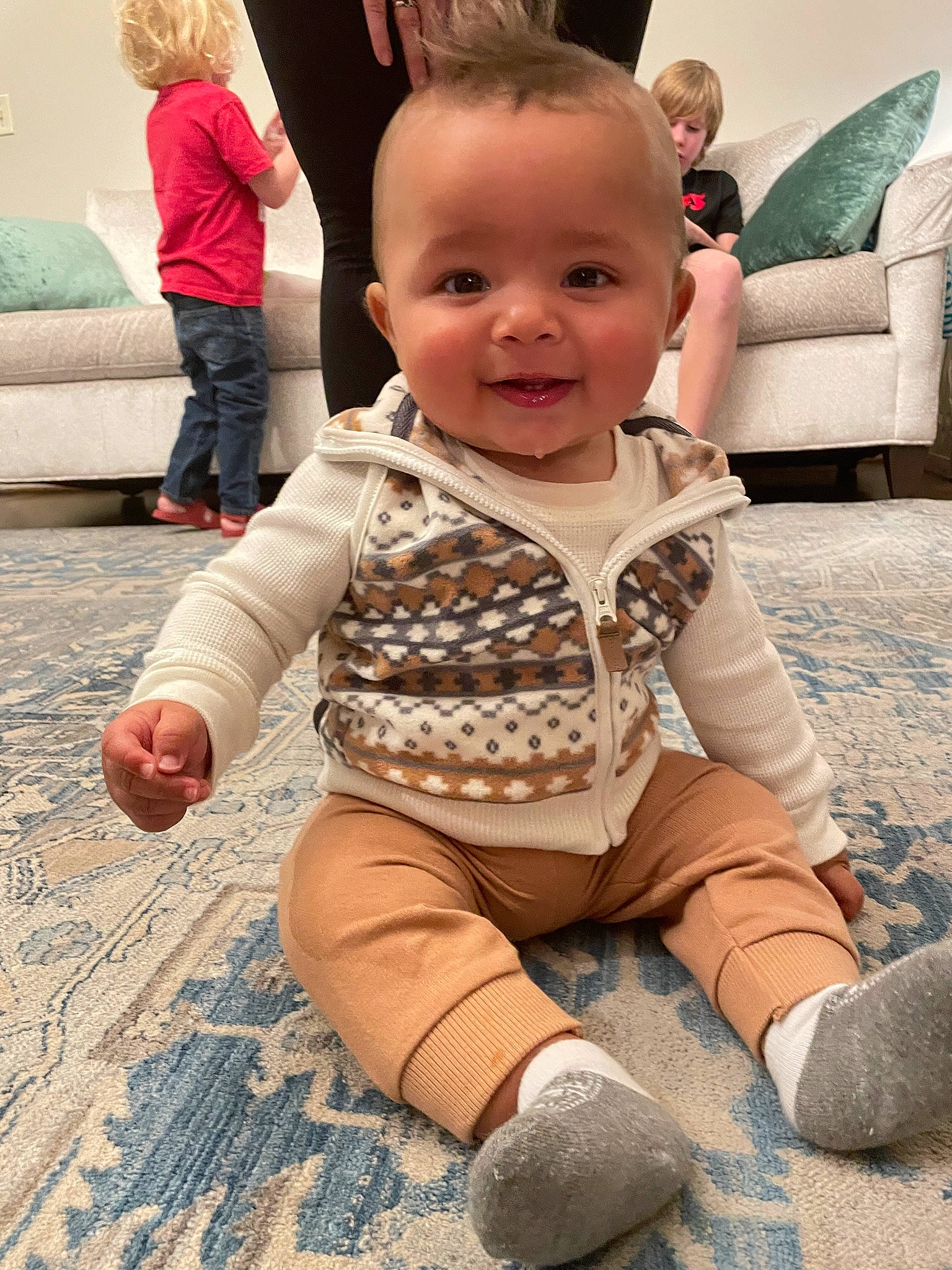 Keenan is registered to the contest to win money with this photo: baby_toddler_clothing, cheek, clothing, eye, face, floor, green, hair, hairstyle, head, human, joint, joy, leg, organ, person, photograph, skin, sleeve, smile