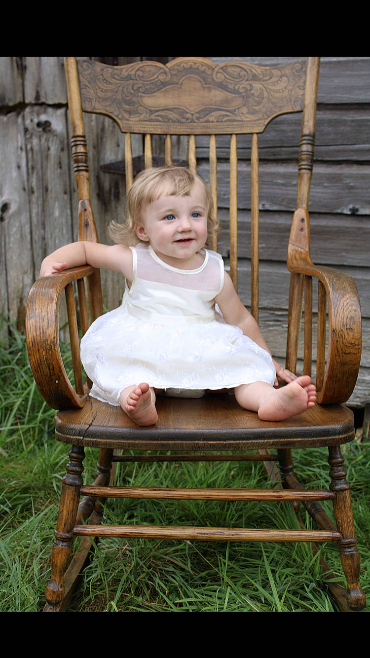 Callie is registered to the contest to win money with this photo: baby, baby_toddler_clothing, chair, child, dress, flash_photography, fun, grass, happy, joy, leisure, musical_instrument, outdoor_furniture, person, product, sitting, smile, summer, swing, table