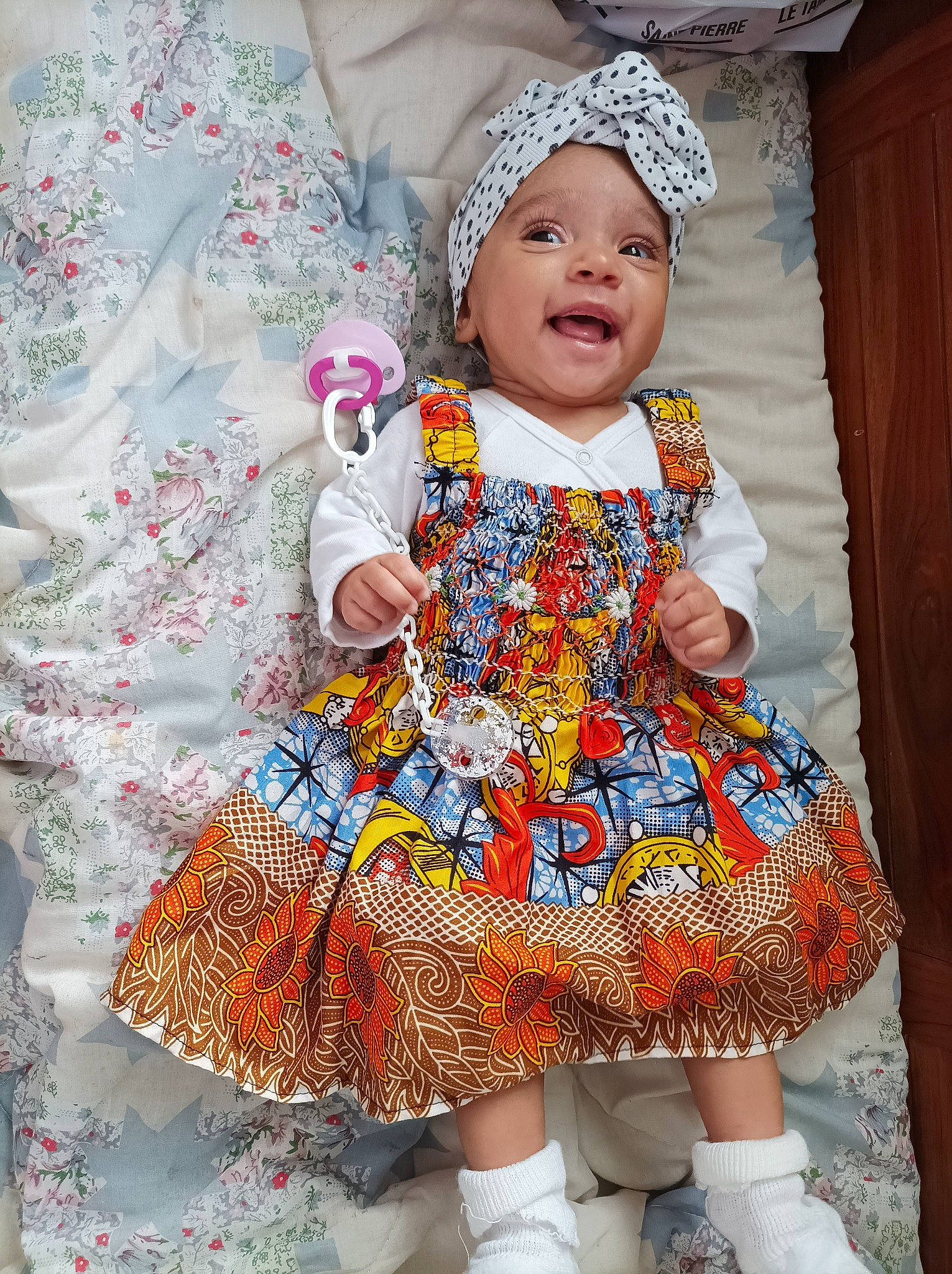 Mencya participe au concours pour gagner de l'argent avec cette photo : baby, baby_toddler_clothing, child, curtain, day_dress, dress, event, fashion_design, hat, headwear, magenta, one_piece_garment, pattern, person, pink, purple, sitting, skin, sleeve, textile