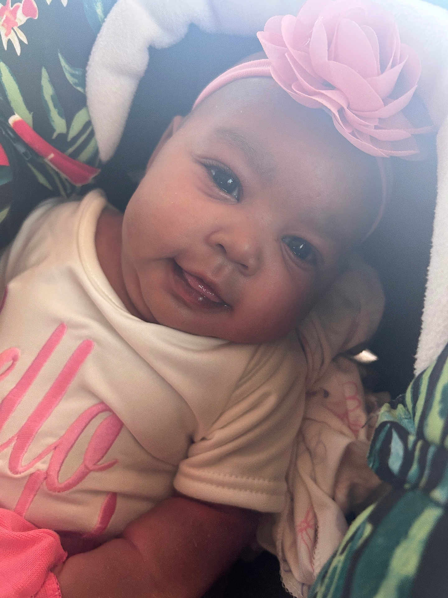 Malani joined the competition — help win amazing prizes! baby, smiling, face, headband, flower, pink, white_shirt, blanket, patterned_blanket, infant, closeup, child, cute, portrait, cozy, soft_lighting, indoors, happy, clothing, baby_girl