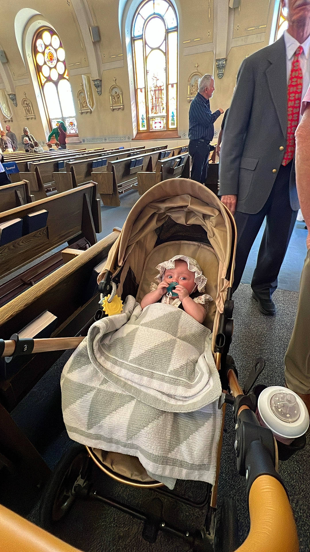 Sophia Valentina joined the competition — help win amazing prizes! baby, blanket, carpet, church, cup_holder, floor, hand, headwear, indoor, infant, lighting, man, pacifier, people, pew, stained_glass, stroller, suit, tie, window