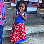 child, girl, boy, traditional_dress, barefoot, curly_hair, smiling, outdoor, concrete, colorful, festival, cultural_event, pillar, purple_fence, casual_clothing, people, portrait, happy, daylight, hands_together