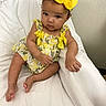 E Zaylee joined the competition — help win amazing prizes! arm, baby, bow, child, couch_cover, curious_expression, cute, eyes, face, floral_print, headband, indoor, infant, leg, portrait, sitting, skin, toes, white_chair, yellow_dress