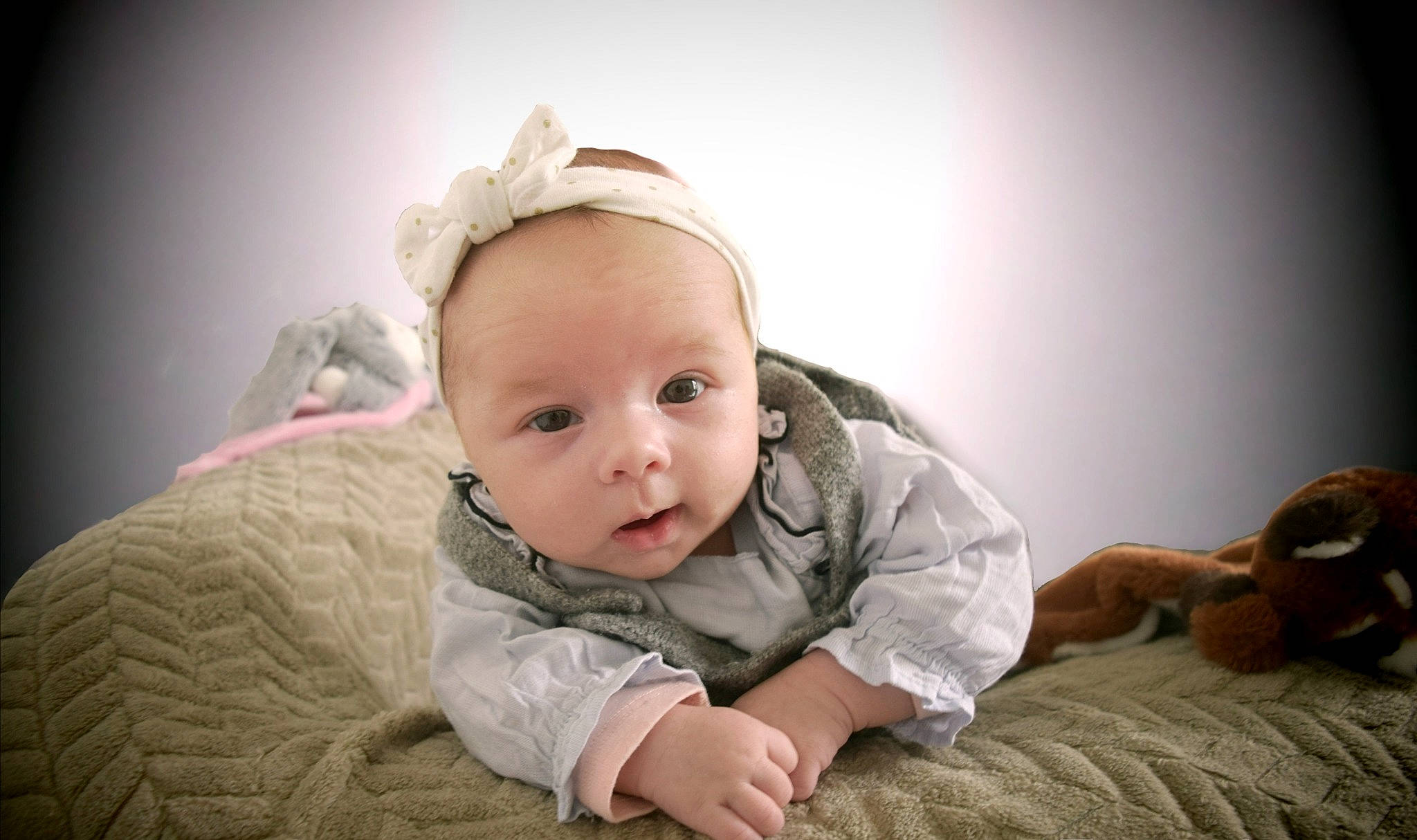 Winona participe au concours pour gagner de l'argent avec cette photo : baby, baby_toddler_clothing, cheek, child, comfort, flash_photography, flooring, fun, fur, grass, happy, headpiece, iris, linens, person, portrait_photography, room, sitting, sleeve, toddler
