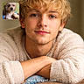 young_man, portrait, blonde_hair, sweater, resting, smiling, face, brown_eyes, dog, small_dog, fluffy_dog, inset_photo, indoor, warm_lighting, casual, relaxed, text_overlay, website_text, human, pet