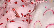 Ja'Zyiah is registered to the contest to win money with this photo: baby, sleeping, pink_onesie, ladybug_pattern, blanket, rainbow_pattern, pacifier_clip, strawberry, slipper, infant, cute, soft_texture, resting, child, cozy, indoor, newborn, person, toddler, comfort