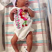 Ja'Zyiah is registered to the contest to win money with this photo: newborn, baby, infant, sleeping, hospital, onesie, cap, pacifier, blanket, striped, baby_id_band, cute, cartoon_character, lying_down, nursery, skin, feet, hands, hospital_bed, peaceful