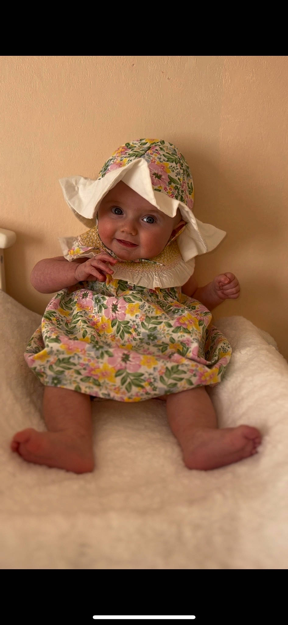Clara is registered to the contest to win money with this photo: baby, baby_toddler_clothing, child, day_dress, dress, fashion_accessory, foot, fun, happy, hat, headwear, human_body, human_leg, joy, pattern, person, pink, sitting, skin, sleeve