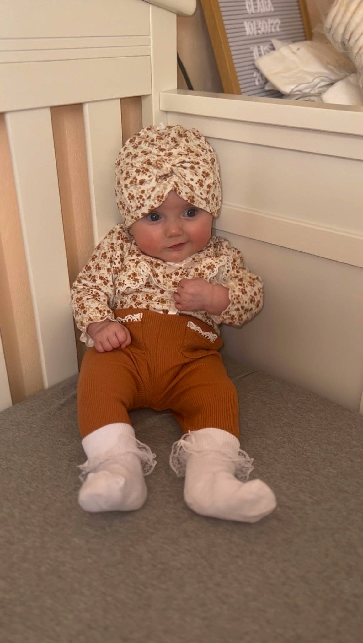 Clara is registered to the contest to win money with this photo: baby, baby_products, baby_sleeping, baby_toddler_clothing, child, comfort, face, fashion_accessory, floor, flooring, foot, headgear, headwear, human_leg, knee, linens, person, sleeve, sock, thigh