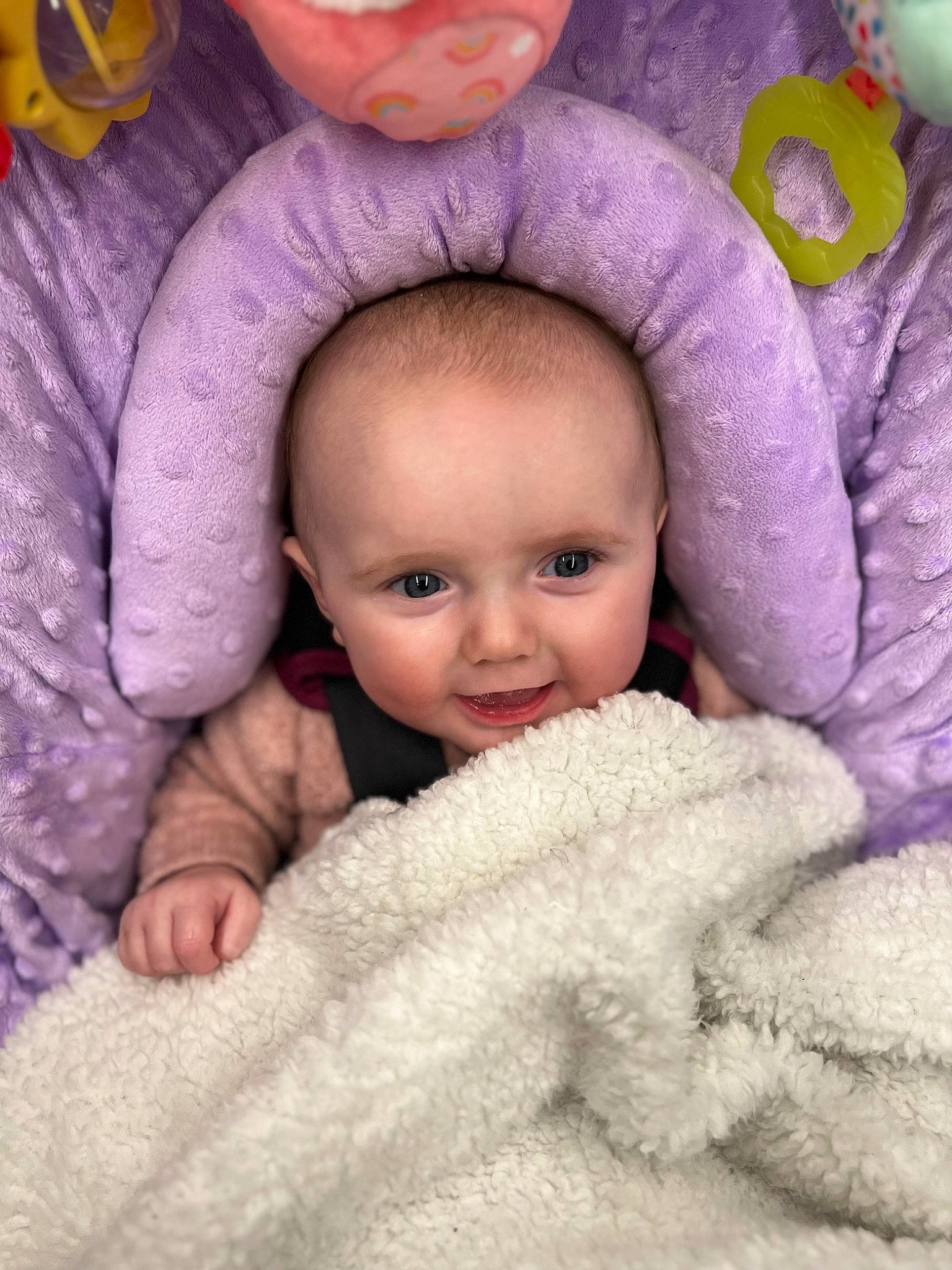 Clara is registered to the contest to win money with this photo: baby, baby_products, baby_toddler_clothing, cheek, child, comfort, eyebrow, fur, happy, linens, magenta, nose, person, pink, product, purple, skin, smile, textile, toddler
