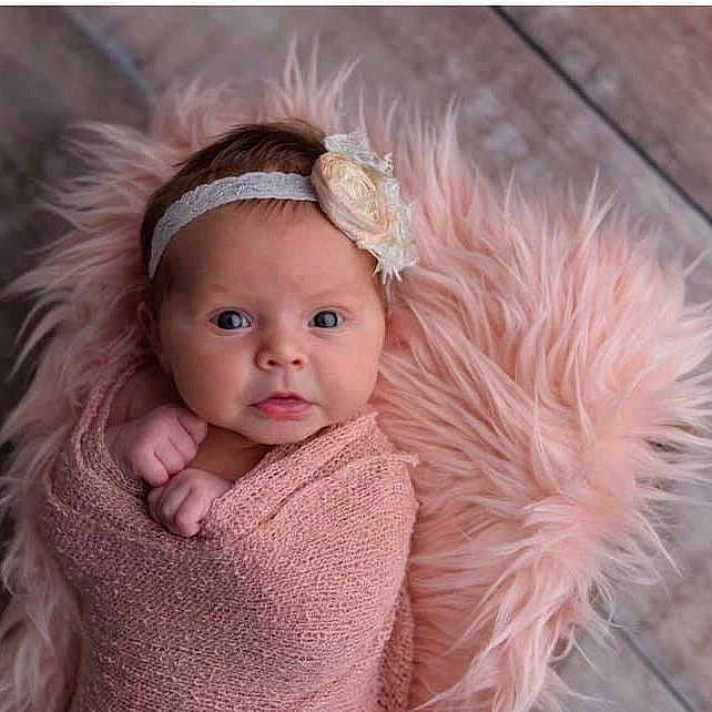 Elowynn is registered to the contest to win money with this photo: baby, cheek, child, child_model, ear, eye, face, fur, hair, hair_accessory, head, headgear, headpiece, iris, lip, outerwear, person, photography, pink, skin