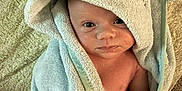 George is registered to the contest to win money with this photo: baby, bath_time, blanket, child, cozy, cute, expression, face, hand, hooded_towel, indoor, infant, pacifier, person, portrait, skin, soft_texture, towel, wrapped, young