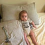 Elijah is registered to the contest to win money with this photo: baby, infant, bed, pillow, pacifier, onesie, blanket, sleepwear, person, indoors, cute, child, resting, lying_down, young_child, neutral_colors, comfort, looking_at_camera, soft_lighting, home