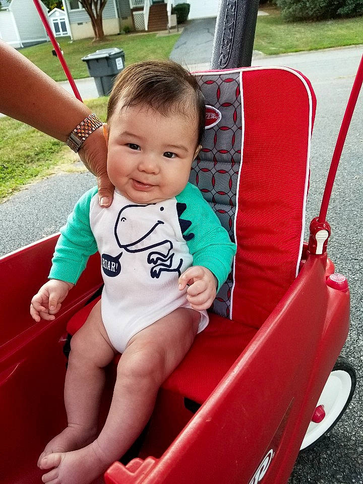 Cillian is registered to the contest to win money with this photo: baby, baby_products, child, fun, human_settlement, leisure, outdoor_play_equipment, person, pink, play, playground, product, public_space, recreation, sitting, skin, smile, summer, swing, toddler