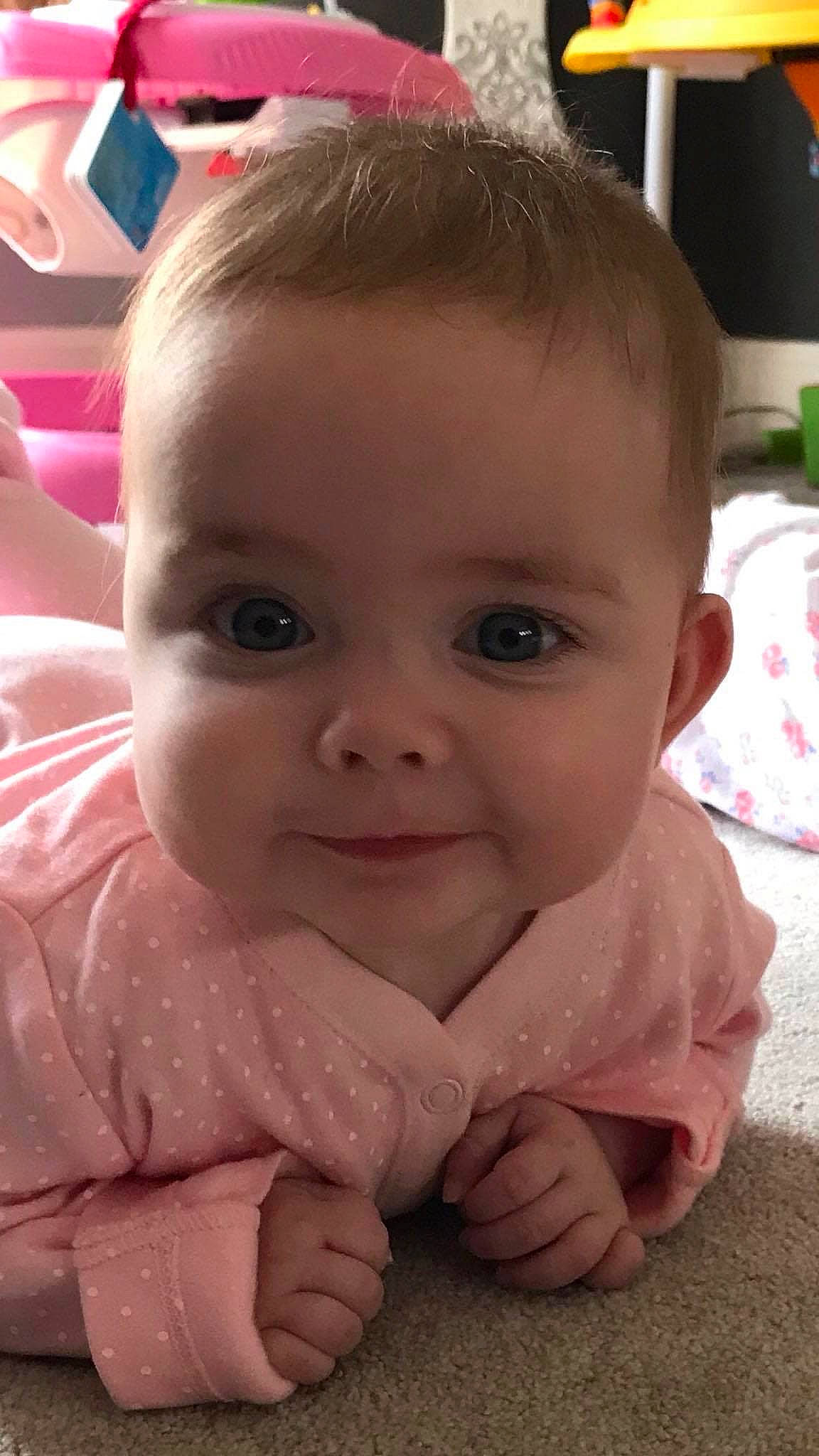 Maisie is registered to the contest to win money with this photo: baby, beauty, cheek, child, chin, close_up, eye, eyebrow, face, facial_expression, forehead, hair, head, lip, mouth, nose, person, pink, skin, smile