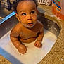 baby, bath, child, cleaning, container, curious, curly_hair, domestic, expression, face, foam, hands, household, infant, kitchen_counter, liquid, sink, skin, soap_bubbles, water