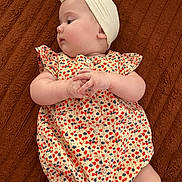 Julia participe au concours pour gagner de l'argent avec cette photo : baby, infant, child, romper, head_wrap, blanket, patterned_clothing, cute, chubby_cheeks, lying_down, soft_skin, portrait, small_hands, side_profile, indoors, fabric_texture, clothing, toddler, young_child, adorable