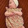 baby, infant, child, romper, head_wrap, blanket, patterned_clothing, cute, chubby_cheeks, lying_down, soft_skin, portrait, small_hands, side_profile, indoors, fabric_texture, clothing, toddler, young_child, adorable