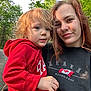 car, casual, child, daylight, forest, gravel, greenery, holding, hoodie, nature, outdoor, person, portrait, red_clothing, road, selfie, smile, toddler, trees, woman