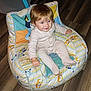 Lenox is registered to the contest to win money with this photo: baby_furniture, blue_eyes, cartoon_pattern, child, comfort, cushioned_chair, cute, happy, home, indoor, pajamas, person, plush_chair, portrait, seated, smiling, striped_clothing, toddler, wooden_floor, young_child