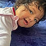 Zoemy joined the competition — help win amazing prizes! baby, child, curly_hair, smiling, face, blanket, blue, clothing, long_sleeve, skin, baby_girl, lying_down, indoor, cute, infant, portrait, expression, young_child, soft_texture, playful