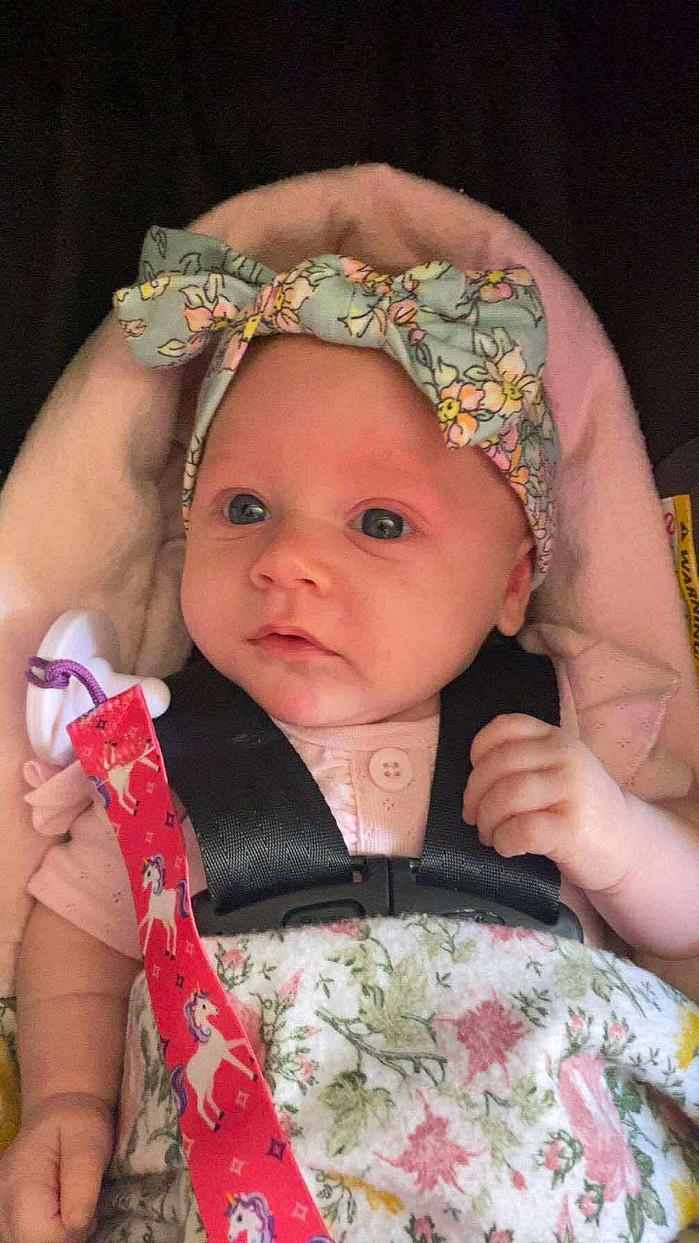 Brinlee joined the competition — help win amazing prizes! baby, blanket, car_seat, child, closeup, clothing, colorful, cute, face, floral, hand, headband, indoors, infant, newborn, pacifier, person, portrait, safety_harness, soft